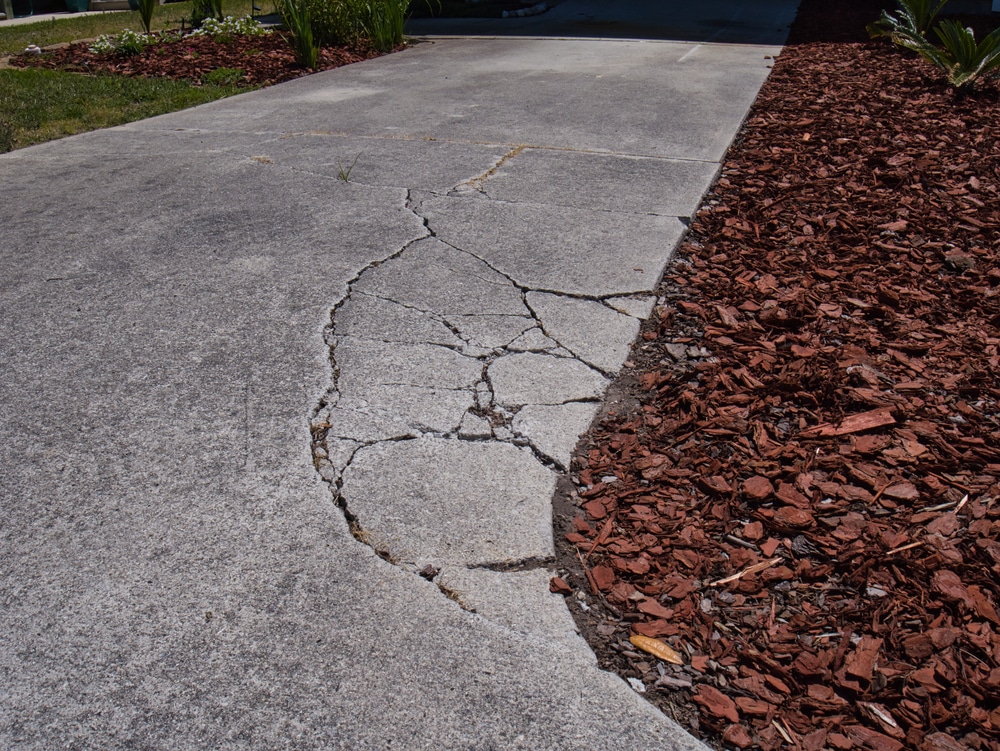 Cracked concrete driveway waiting to be patched